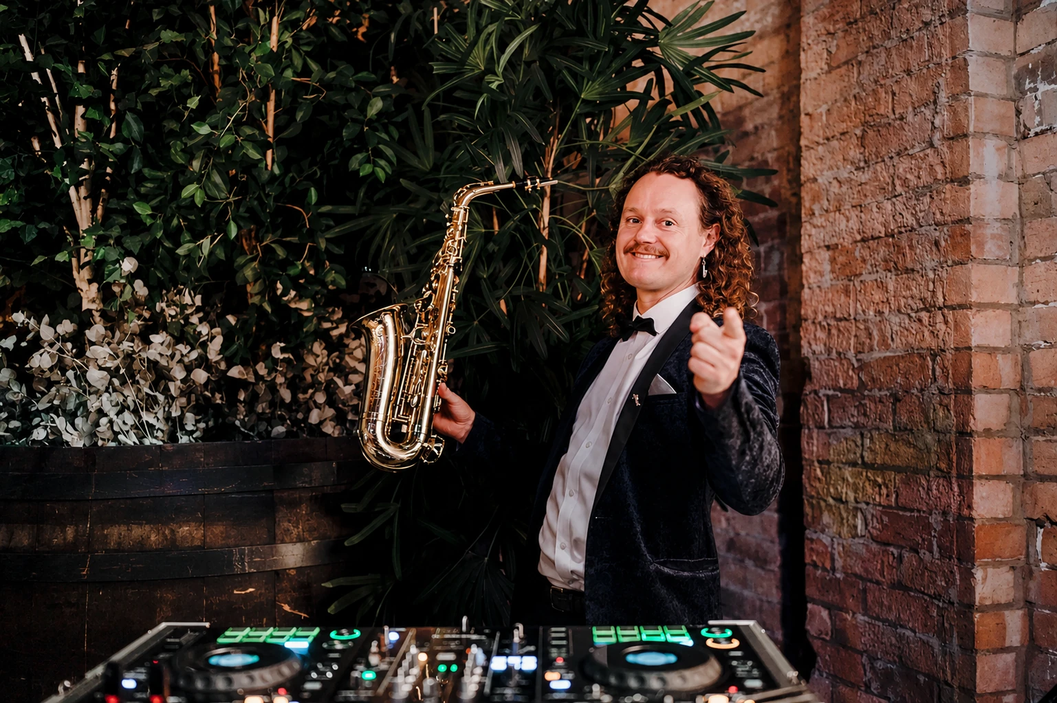Ian performing saxophone at a wedding reception